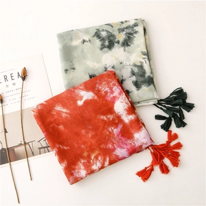 Artistic tie-dye cotton linen scarf with tassels in orange and teal for beach sun protection