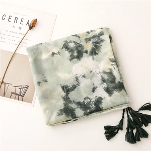 Detail of artistic ink painting cotton scarf with deep green tassels and soft texture