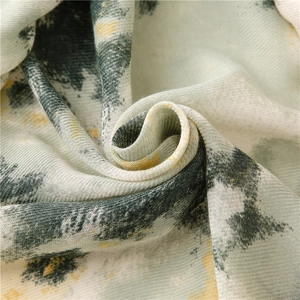 Macro shot of cotton linen scarf showing grey and yellow abstract print and fabric texture