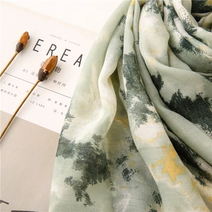 Detail shot of light green linen-feel scarf with abstract yellow ink wash floral print
