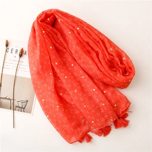 Red cotton linen scarf with gold sequins and fringe tassels on a minimalist background