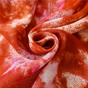 Macro shot of red and white marble-patterned cotton-linen scarf fabric with soft texture