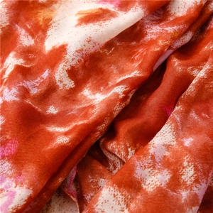 Detailed macro view of abstract ink painting patterns on soft cotton-linen fabric scarf