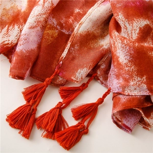 Detail of light cotton linen scarf with orange tassel fringe and ink painting print