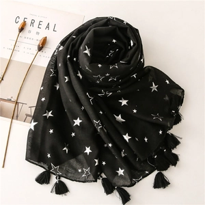 Detailed view of black cotton linen scarf with silver stars and tassel decorations