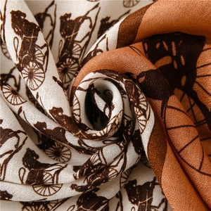 Detail view of cotton-linen scarf showing retro horse carriage print and fabric texture