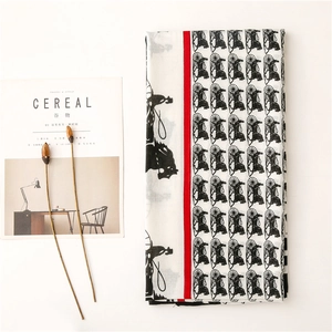 Detail view of cotton linen scarf with horse carriage print and red vertical stripes