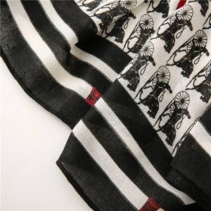 Detail of horse carriage vintage print and striped border on light cotton-linen scarf