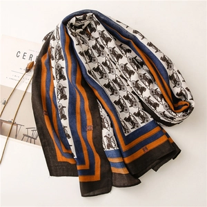 Detail of printed scarf with carriage pattern and geometric stripes on lifestyle background