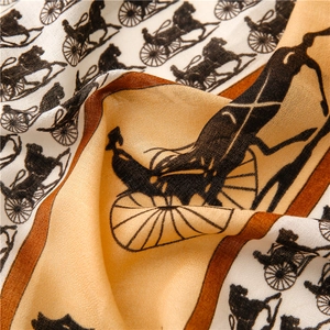Detailed view of horse carriage print on beige linen-feel scarf with rich texture