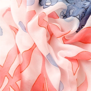 Close-up of lightweight floral silk scarf with soft pink and blue abstract print texture