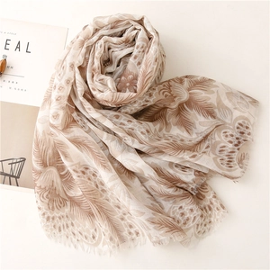 Detailed view of soft khaki floral voile scarf with delicate fringe edges and brown prints