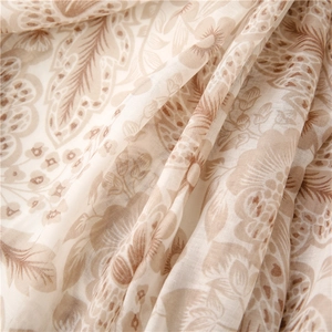 Detail view of khaki floral voile scarf featuring semi-transparent soft cotton-linen texture