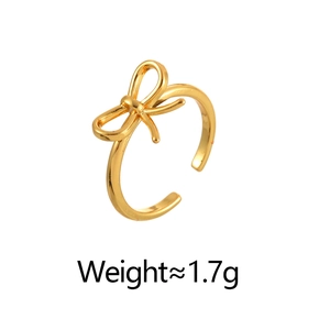 Close-up of a delicate golden bow ring with adjustable open shank weighing 1.7g