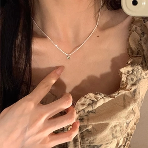 Minimalist silver necklace featuring a sparkling green round zircon pendant for women