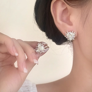 Elegant silver irregular fireworks stud earrings with shimmering cubic zirconia on model