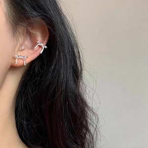 Elegant silver bow stud earring and ear cuff set shown on model for a minimalist look