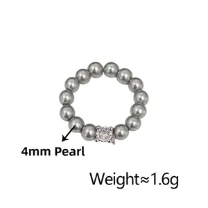 Detail of 4mm grey pearl stretch ring with a sparkling center zircon, weighing 1.6g
