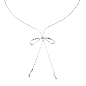 Silver bow necklace with long tassel and water drop pendants on white background