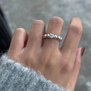 Detailed view of silver beaded ring featuring a princess cut clear cubic zirconia stone