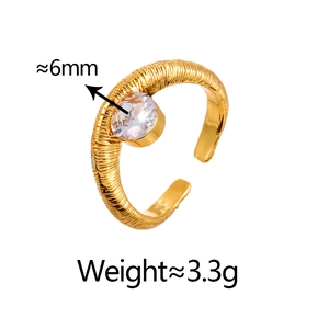 Detail of vintage texture gold ring with 6mm cubic zirconia stone and open band