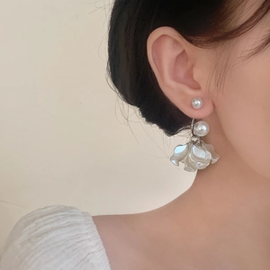 Elegant pearl and white acrylic flower petal tassel earrings shown on a model