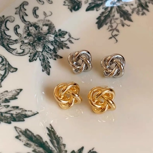 Elegant woven twist knot stud earrings in polished gold and silver metal finishes