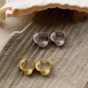 Twisted Mobius hoop earrings in gold and silver finish with textured surface