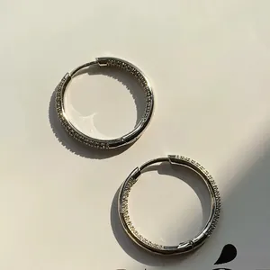 Macro shot of silver inside-out hoop earrings with micro-pave cubic zirconia stones