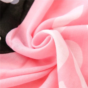 Detailed macro view of soft pink and white linen scarf fabric with fine weave texture