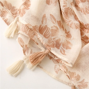 Macro detail of cotton linen scarf showing vintage floral print and handmade tassels