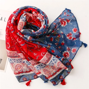 Close-up of red and blue floral scarf with elegant fringe detail and soft voile texture