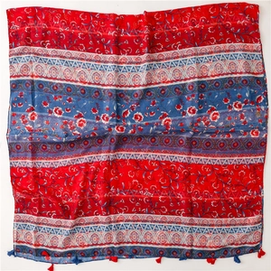 Close-up of red and blue ethnic floral pattern cotton scarf with fringe tassel details