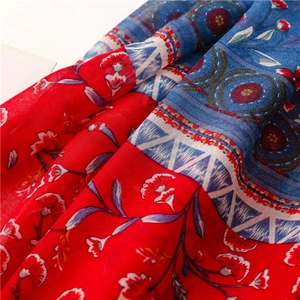 Close-up of ethnic floral pattern on soft cotton-linen shawl with red and blue accents