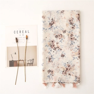 Floral cotton voile scarf with purple flower prints and pink tassels on white background