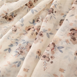 Detail of floral voile scarf fabric texture with soft drapes and delicate flower pattern