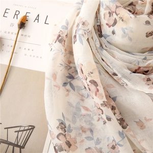 Close-up of soft bali yarn scarf with vintage floral print and linen texture