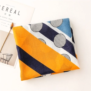 Detail of cotton linen scarf with geometric orange and navy blue striped pattern