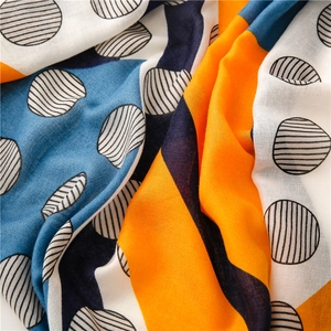 Detailed view of the soft cotton linen fabric featuring colorful geometric patterns