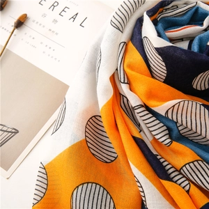 Detailed texture of cotton linen scarf with orange and blue geometric color blocks