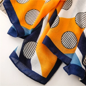 Detail of orange and blue geometric pattern cotton linen scarf with fine woven texture