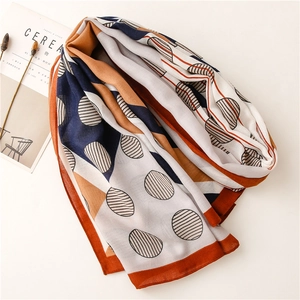 Detail of orange and blue geometric dot pattern on a lightweight cotton linen scarf