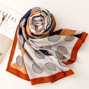 Artistic geometric patchwork scarf with orange and navy print on minimalist background