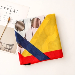 Detail view of cotton linen scarf with abstract geometric patterns and bright yellow colors