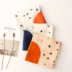 Detail of lightweight cotton linen scarves featuring abstract geometric patterns