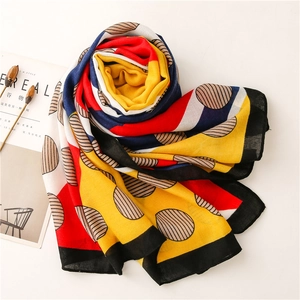 Artistic polka dot linen scarf displayed on a minimalist background with aesthetic props