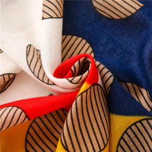 Macro detail of lightweight scarf fabric with navy and red geometric stripe patterns