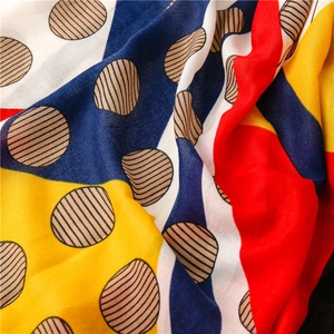 Close-up of linen-cotton scarf with geometric color blocks and textured dots
