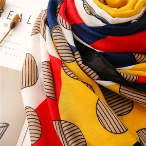 Detailed view of lightweight cotton-linen scarf with colorful geometric prints