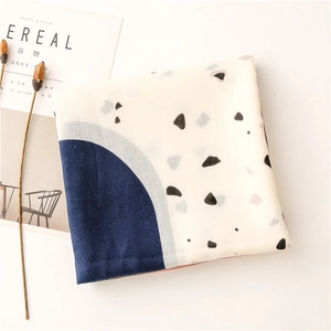 Close-up of cotton linen shawl with navy blue geometric abstract terrazzo patterns
